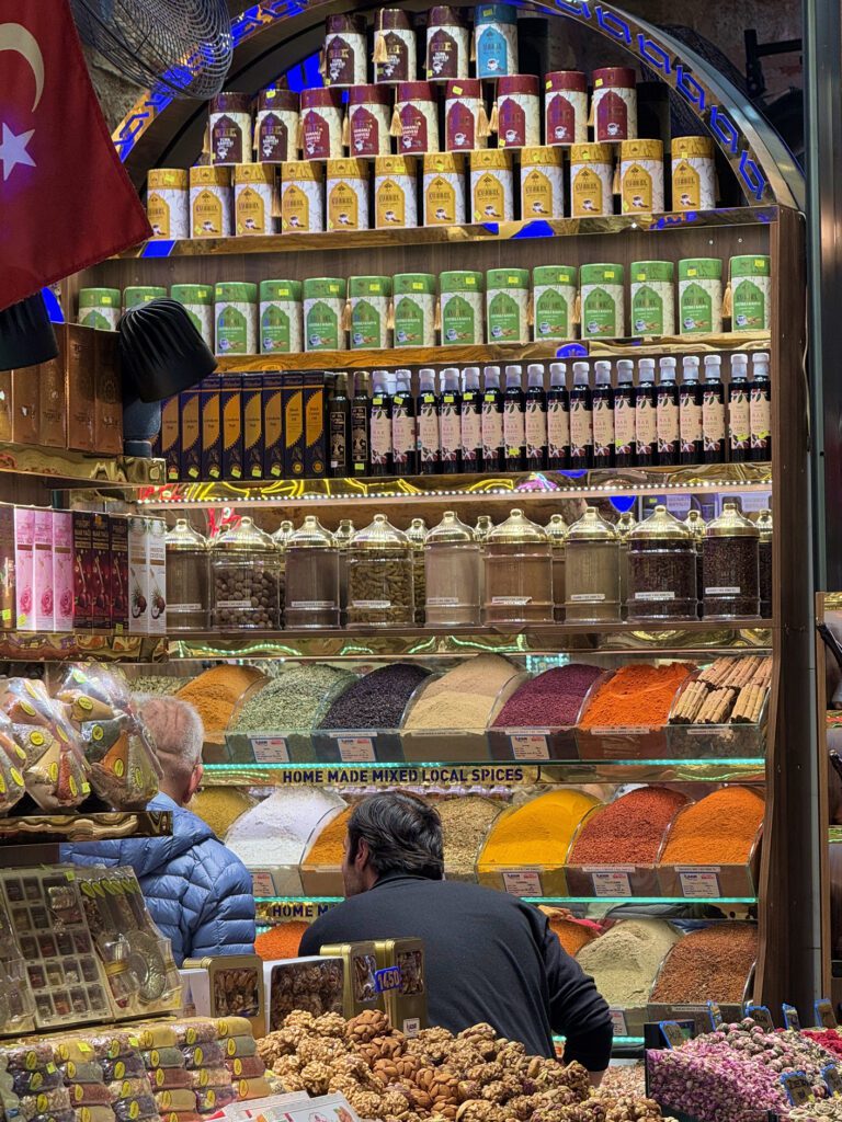 Shoppers exploring vibrant spice displays at Istanbul Egyptian Bazaar market