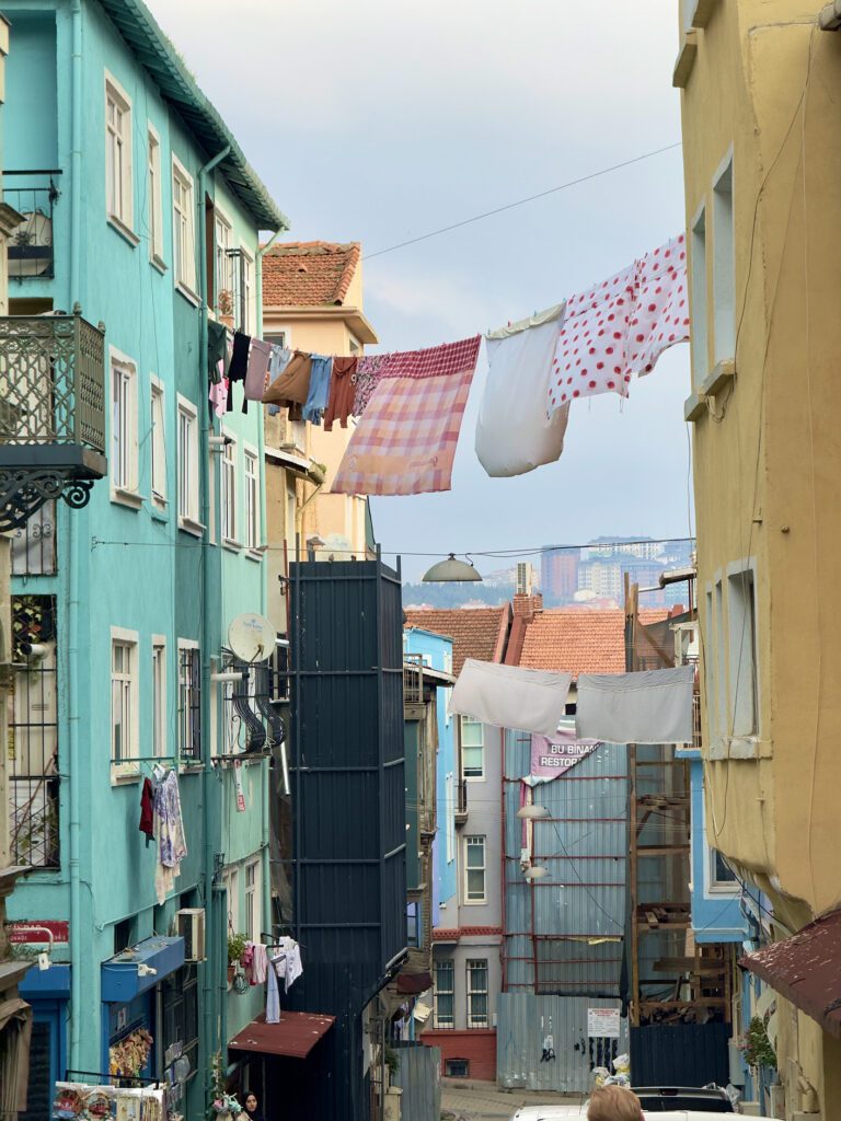 Narrow Balat street with hanging laundry, authentic scene from an Istanbul itinerary
