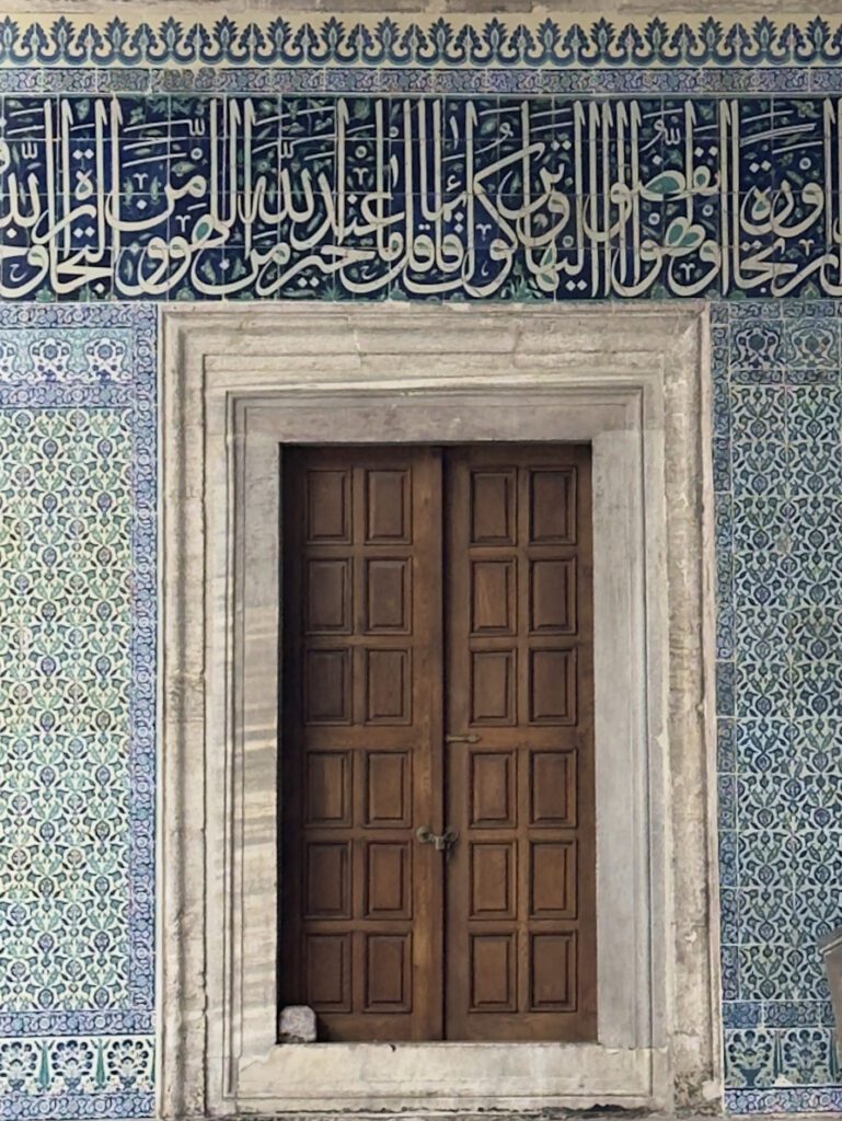 Tiled entrance door inside Yeni Mosque Istanbul, detailed stop on a cultural itinerary